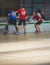 View of floorball match game, court hall indoor venue with junior teenage children school team playing in the background, floor