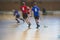 View of floorball match game, court hall indoor venue with junior teenage children school team playing in the background, floor