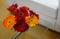 View of flowers in vase on a glass top table and sofa in trade show stall