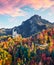 View from flying drone. Amazing autumn scene of Neuschwanstein Castle, 19th-century hilltop fairytale castle. Great morning scene