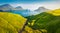 View from flying drone. Colorful summer scene of Faroe Islands and Tindholmur cliffs on background. Misty morning view of Vagar is