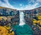 View from flying drone of Gufufoss Gufu Waterfall. Amazing midnight sun scene of typical volcanic landscape of Iceland, Europe.