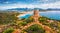 View from flying drone. Impressive summer view of Torre di Porto Giunco tower on Carbonara cape. Aerial morning scene of Sardinia