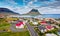 View from flying drone. Splendid morning cityscape of Grundarfjordur town with Kirkjufell Mountain on background. Aerial view of G