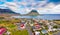 View from flying drone. Splendid morning cityscape of Grundarfjordur town with Kirkjufell Mountain on background. Aerial view of G
