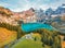 View from flying drone. Stunning autumn view of unique Oeschinensee Lake. Great morning scene of Swiss Alps with Bluemlisalp mount
