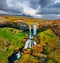 View from flying drone. Stunning morning scene of Sheep`s Waterfall. Aerial summer view of Iceland, Europe. Beauty of nature conc