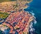 View from flying drone. Sunny summer cityscape of Alghero port, Province of Sassari, Italy, Europe. Colorful morning scene of Sard