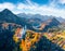 View from flying drone. Unbelievable autumn scene of Neuschwanstein Castle, 19th-century hilltop fairytale castle. Wonderful morni