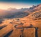 View from flying drone of winding road in Dolomite Alps. Great sunrise on Giau pass