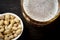 View of the foam of delicious beer in a glass and pistachios in a white bowl