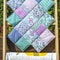 View of a folded Quilts On Wooden Stand,