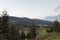 View of forest trees, houses, mountains