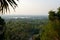 View on forest and Wat Yansangwararam temples and Pattaya city on the horizon from staircase.