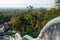View on forest and Wat Yansangwararam temples and Pattaya city on the horizon from staircase