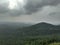 The view of a forest water bodies and green plants and rain bearing clouds in monsoon season from a mountain in indore india.