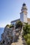 View of the Formentor cape lighthouse on the cliff with the Mediterranean sea in the background in Palma de Mallorca Balearic