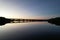 View of Fort Hamer Bridge under the blue sky reflected in the water at sunset