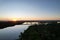 View of Fort Hamer Bridge under the blue sky reflected in the water at sunset