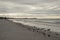 View of Fort Meyers in background during sunrise along beachfront on stormy morning along Fort Myers Beach, Flo