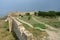 View of fortified wall and watchtower of middle stronghold in old turkish fortress