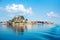 View of the fortress of Corfu from the sea in the morning mist with a trace of waves from the ferry. popular tourist attractions.
