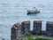 View from the fortress wall of a small boat on the sea surface. Part of the tower of the famous castle Rumeli Hisari on the Bospho