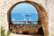 View through fortress window on sailing boats and yachts on blue sea