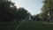 View of fountain stream in park. People walk in green park on their weekend.