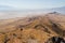 View from Frary Peak on Antelope Island, Great Salt Lake, looking south on the spine of the island. Lonely girl hiking on trail