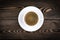 view of a freshly brewed mug of espresso coffee on rustic wooden background with woodgrain texture. Coffee break style, concept.