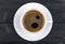 view of a freshly brewed mug of espresso coffee on rustic wooden background with woodgrain texture. Coffee break style, concept.