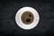 view of a freshly brewed mug of espresso coffee on rustic wooden background with woodgrain texture. Coffee break style, concept.