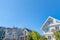 View of front exterior of houses from below against the clear blue sky in San Francisco, CA
