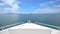 view of front luxury speedboat with a beautiful ocean and mountain in background