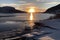 view of frozen fiord with a view of the sunrise, highlighting the beauty and tranquility of the environment