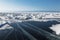 View of the frozen Lake Baikal with clear ice and ice hummocks on a sunny winter day