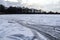 View at a frozen lake during winter with lots of ice skating tracks