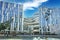 View on futuristic shopping center against spectacular blue clear sky, fluffy cloud