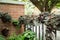 View of the garden landscape  hanging flowers and plants on the gate in residential house