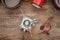 View of gas burner, spark lighter, metal dishes and cup on wooden table