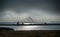 View from the German island Poel over the Baltic Sea to the industrial port of Wismar on a dreary cloudy day, copy space in the