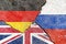 View of Germany, Russia, UK flags icon on weathered cracked wall background