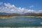 View of the germasogeia dam in Cyprus, taken on a bright blue sky day with beautiful clouds sitting above the mountains