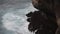 View of the giant waves, foaming and splashing in the ocean near the Ulwatu cliff in Ulwatu Temple at Bali Indonesia