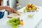 View of girl cutting tasty banana on chopping board