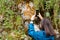 View of a girl photographing moss with a phone, flowers for her blog. Travel, travel photos, blog, vlog