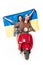 View of girl sitting on red scooter and holding Ukranian flag and young man looking forward isolated on white