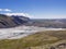 View on glacier lagoon with icebergs and tongue of Skaftafellsjokull, colorful rhyolit mountains in Skaftafell