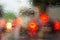 View through the glass of the car on the lights of cars in the rain. Blur on wet glass